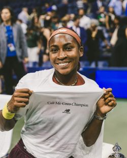 Coco Gauff wearing the Call Me Champion t-shirt on the court after her US Open win